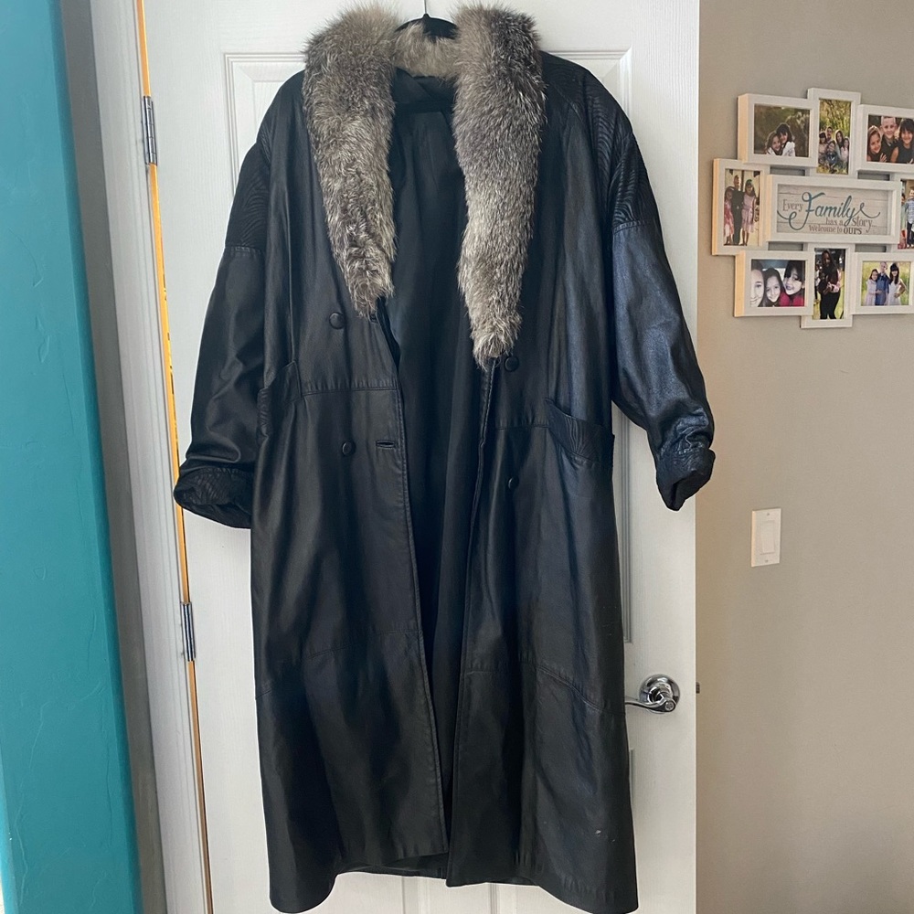 Vintage black leather jacket with fur trim.